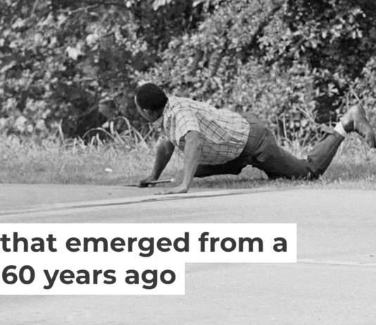 James Meredith looks at Aubrey Norvell, partially hidden behind foliage, after Norvell shot him in Hernando, Miss., on June 6, 1966. AP Photo/Jack Thornell